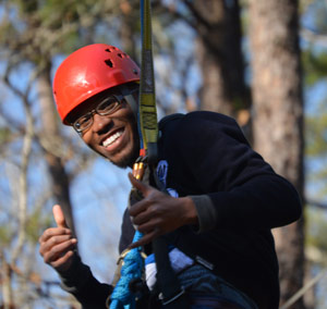 excel participant giving thumbs up ready to go on zipline
