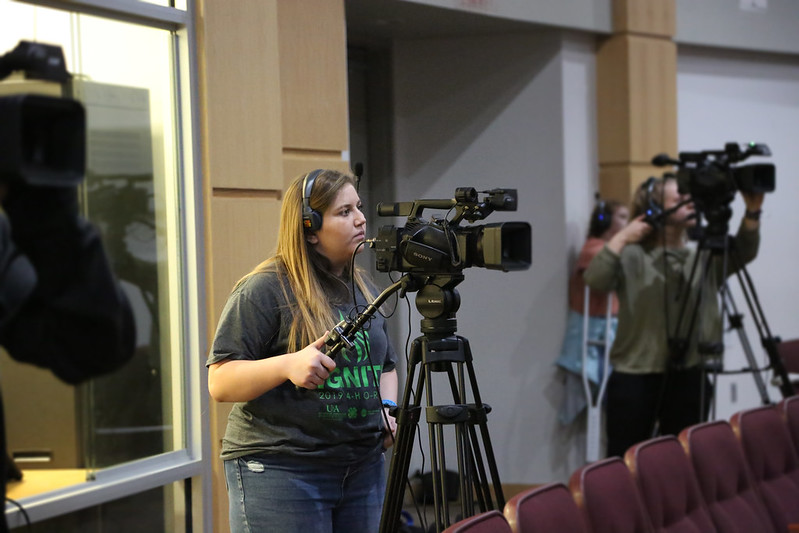 4-H member working a large camera.