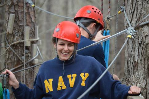 members from the navy laughing on ropes course