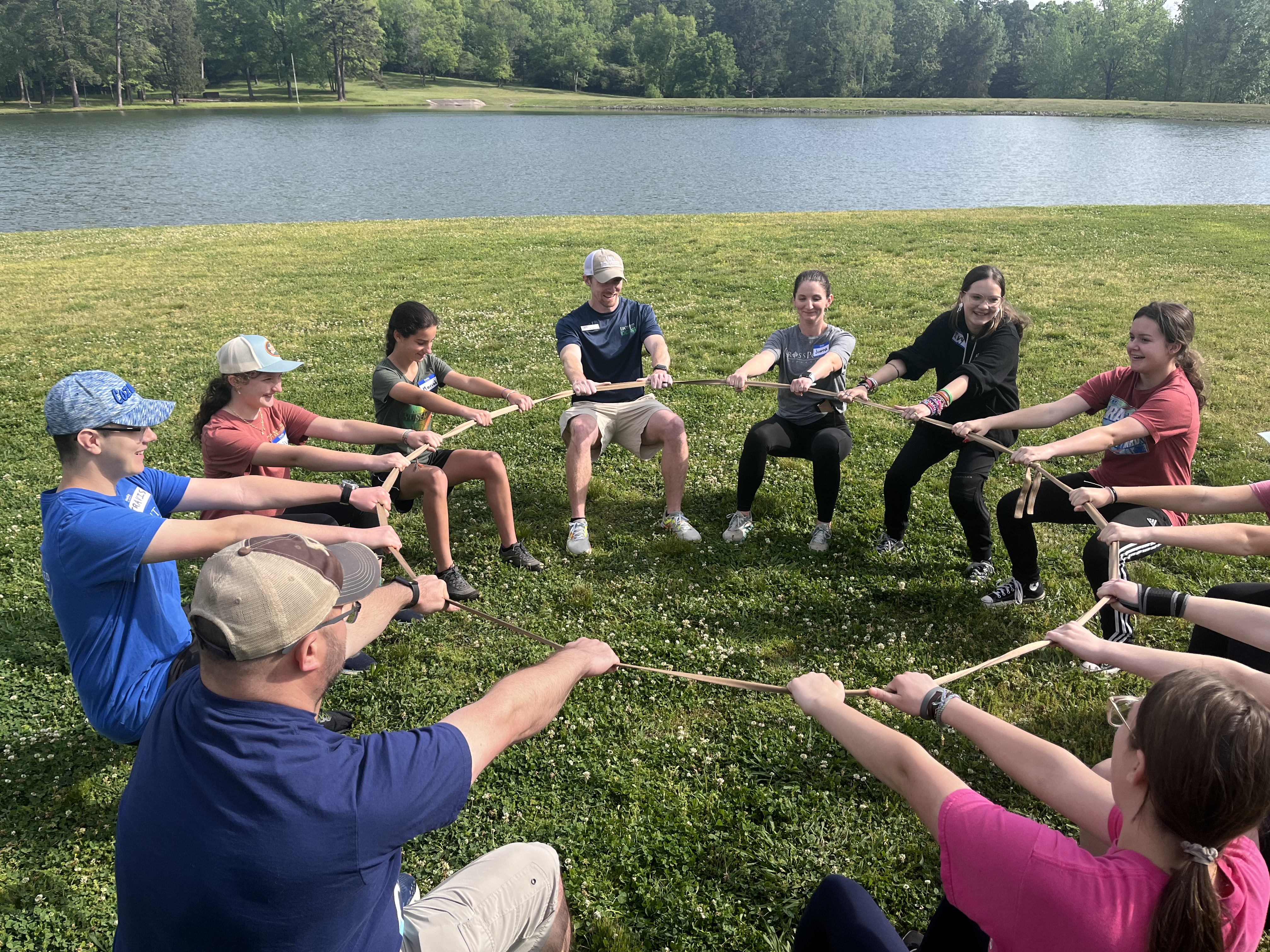 Participants leaning back on a rope with an activity 
